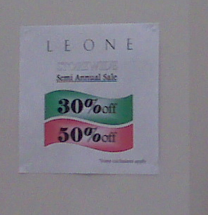 LeoneSaleSign1 These signs were taped on several of the walls, all over the store. FIrst of all, can;t they get professional, calssy signs made? Second, print them on expensive paper, not regualr photocopier paper. And third, find a nice way to attach them to the wall, not globs of gluey stuff. Even H&M wouldn't use signage like this.